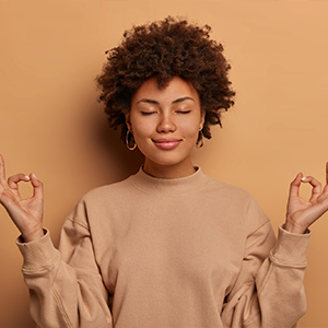 Woman with eyes closed working on her mindset