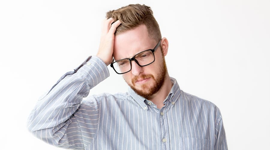 Man frustrated with hand on his head