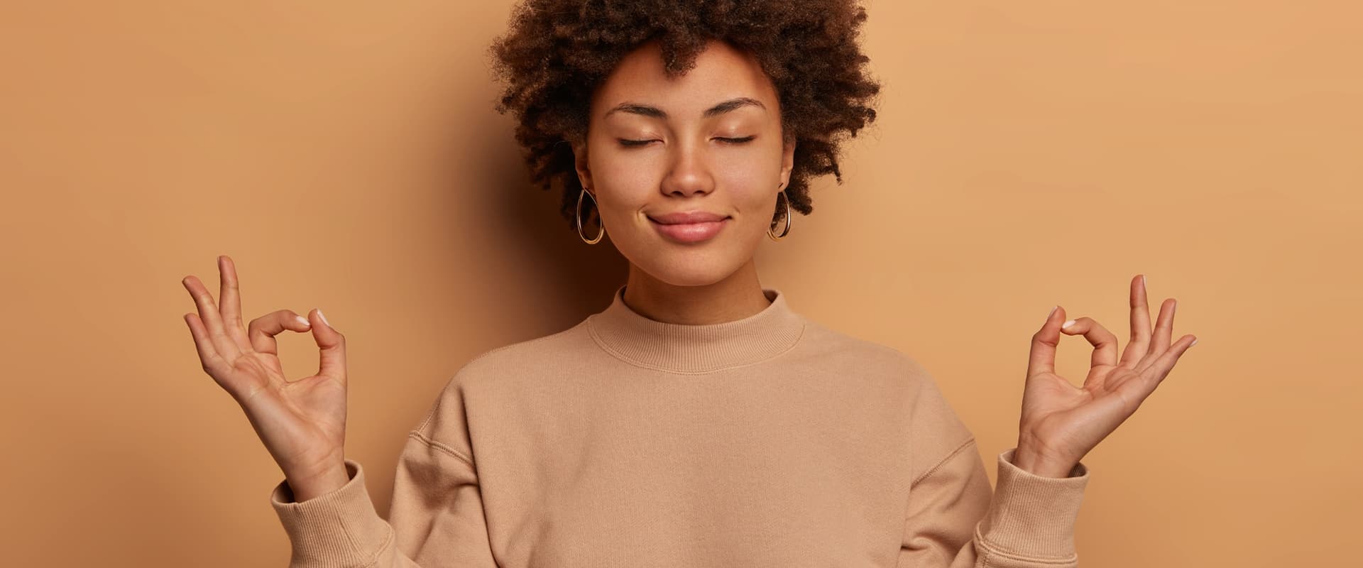 A woman with her eyes closed focusing on her mindset